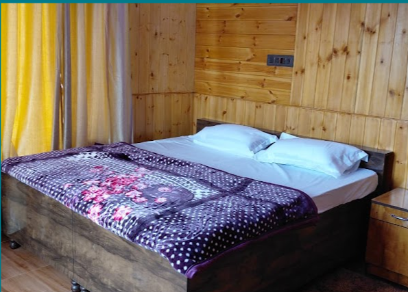 Double bed room with wood panelling at A Day in Rajgundha
